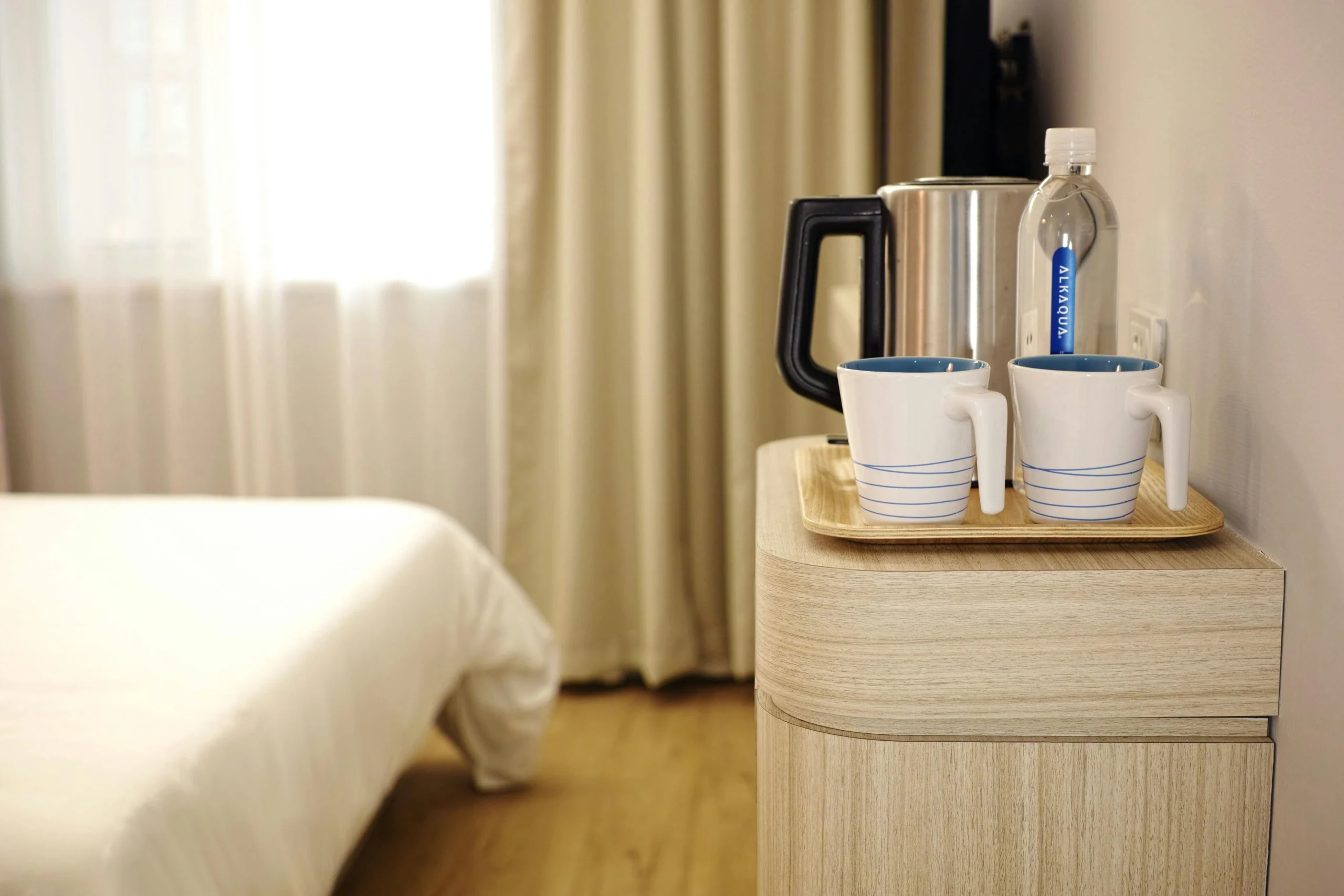 Travel Suitcase with Sun Hat in a Hotel Room